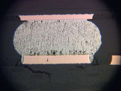 an insidious failure mode known as pad cratering beneath a BGA solder ball.